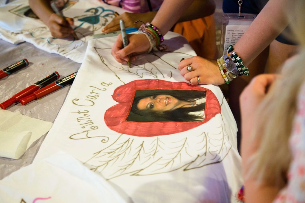 Camp Courage art students decorate an art project.