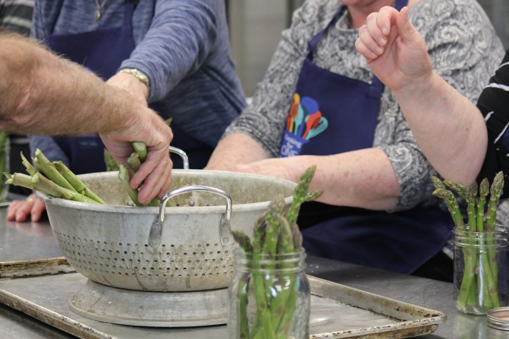 Cooking for One participants prepare asparagus for cooking