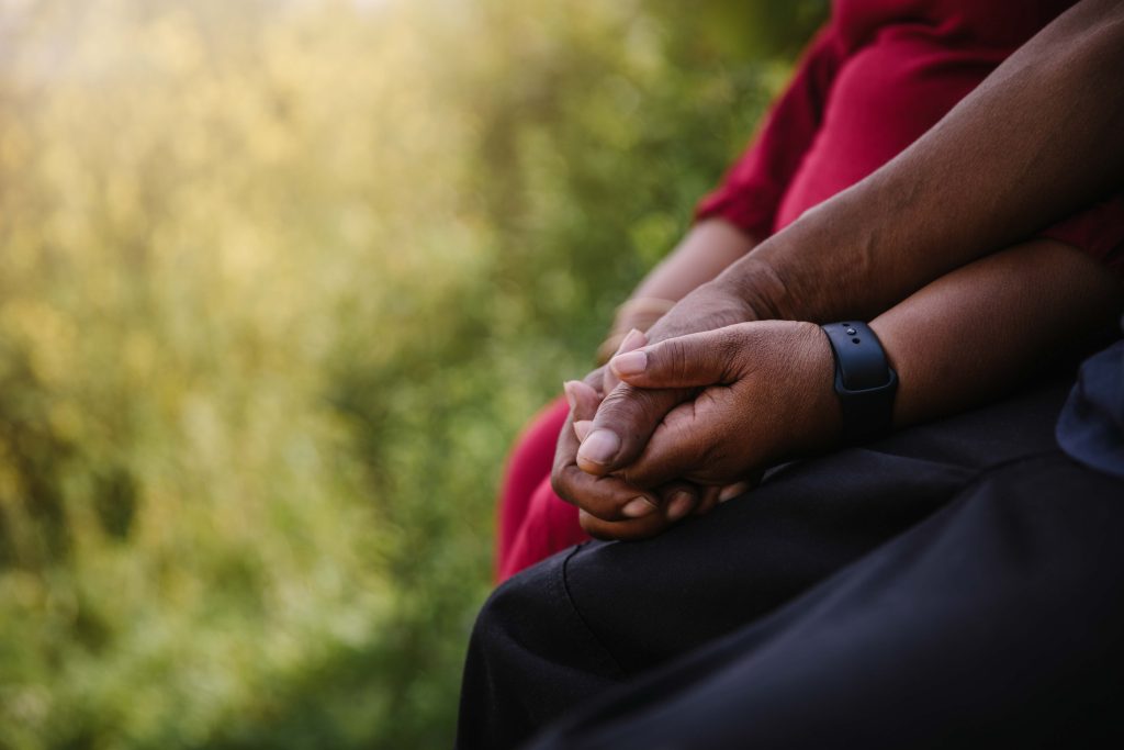 close up of a man and woman holding hands