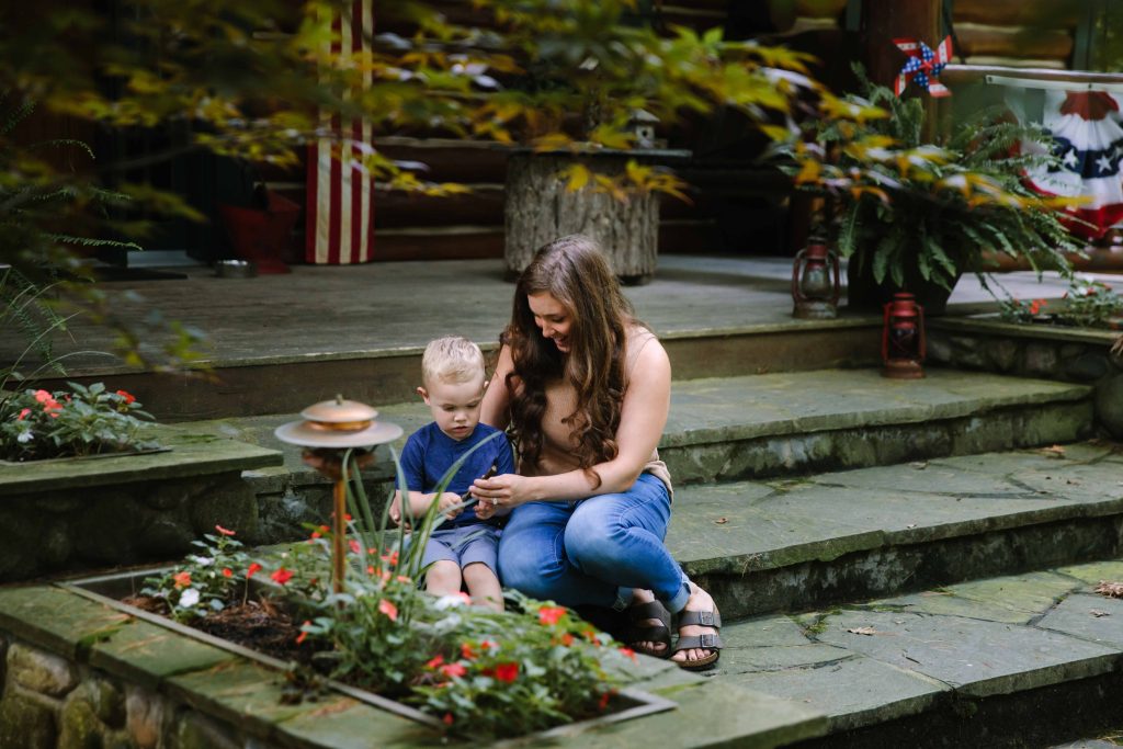 A woman and her toddler son in a garden