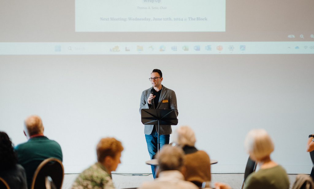 Harbor Hospice Board member shares a presentation at a meeting