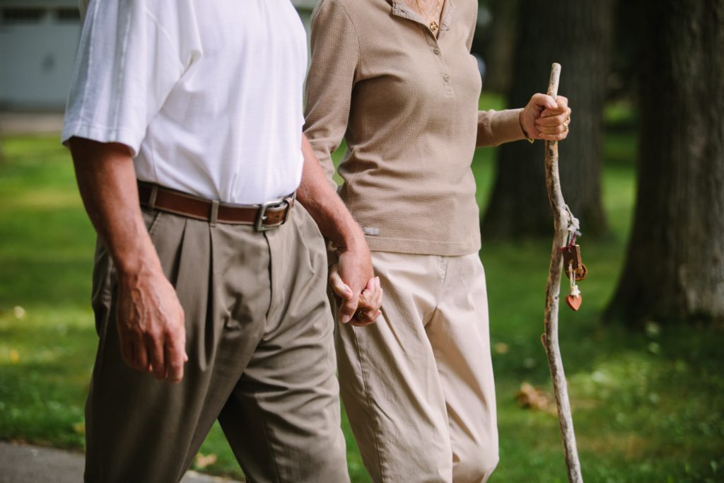 Older couple walking and holding hands