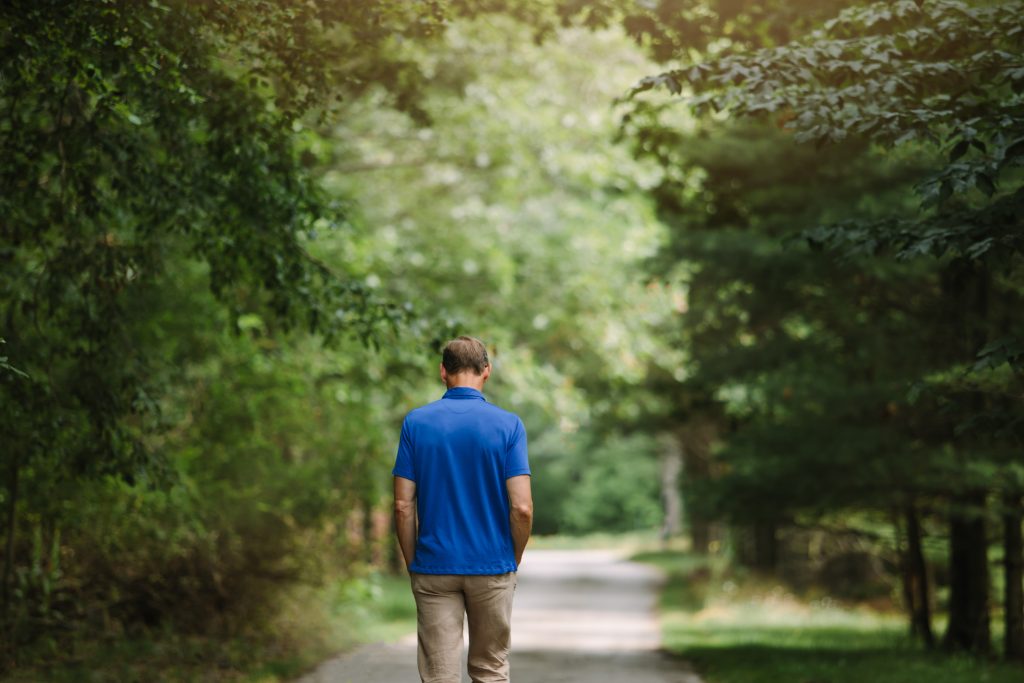 man walking down path