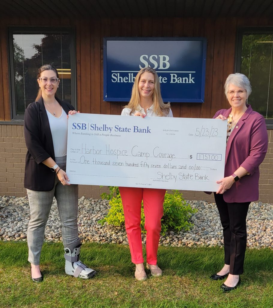 Shelby State Bank staff give check to Harbor Hospice