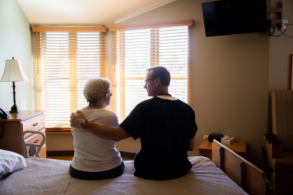 Harbor Hospice chaplain visits with a Harbor Hospice patient in her room