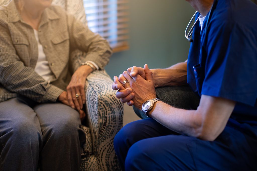 Harbor Hospice nurse talks with an older female patient