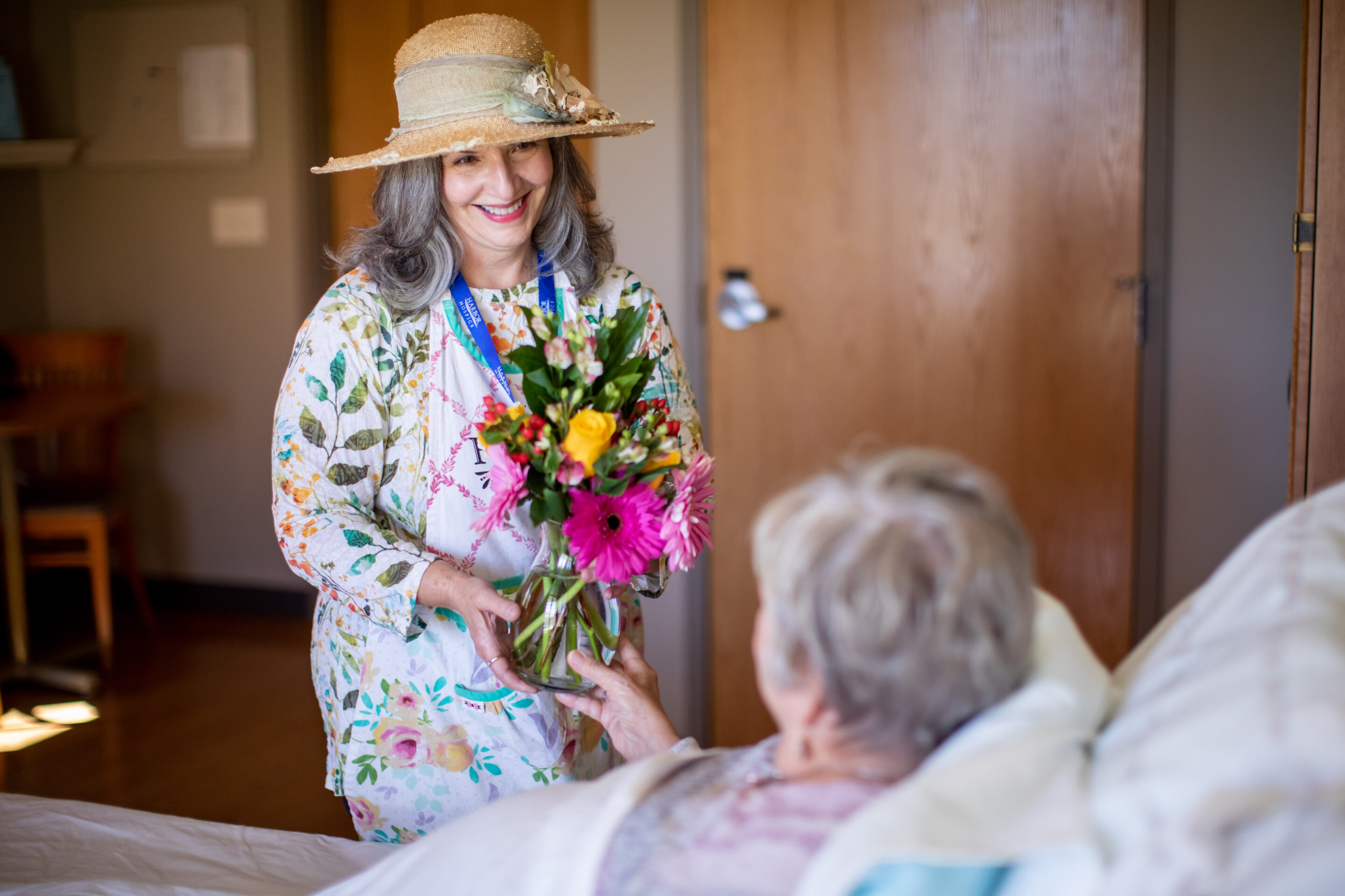 Volunteer with flowers for patient